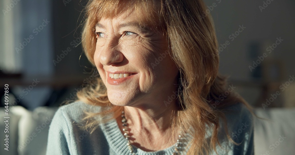 Happy, thinking and a senior woman on the sofa in a home living room for peace, calm and retirement.