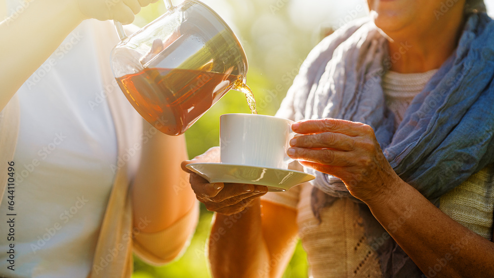 Pouring black tea into cup