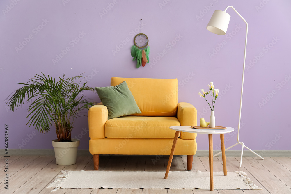 Interior of living room with dream catcher and armchair