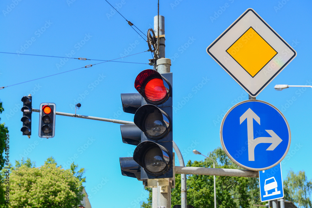 View of traffic lights with road signs in city, closeup