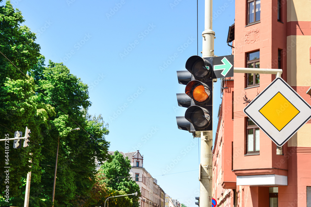 View of yellow traffic light with road signs in city, closeup