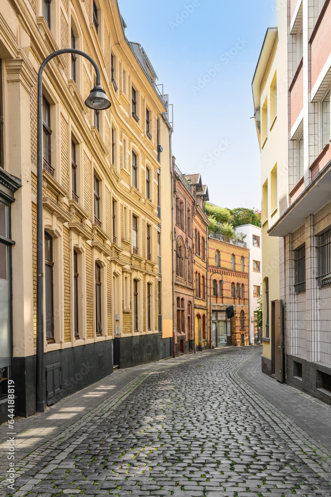 View of old houses with paving stones on city street