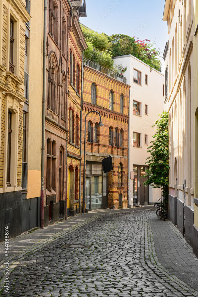 View of old houses with paving stones on city street