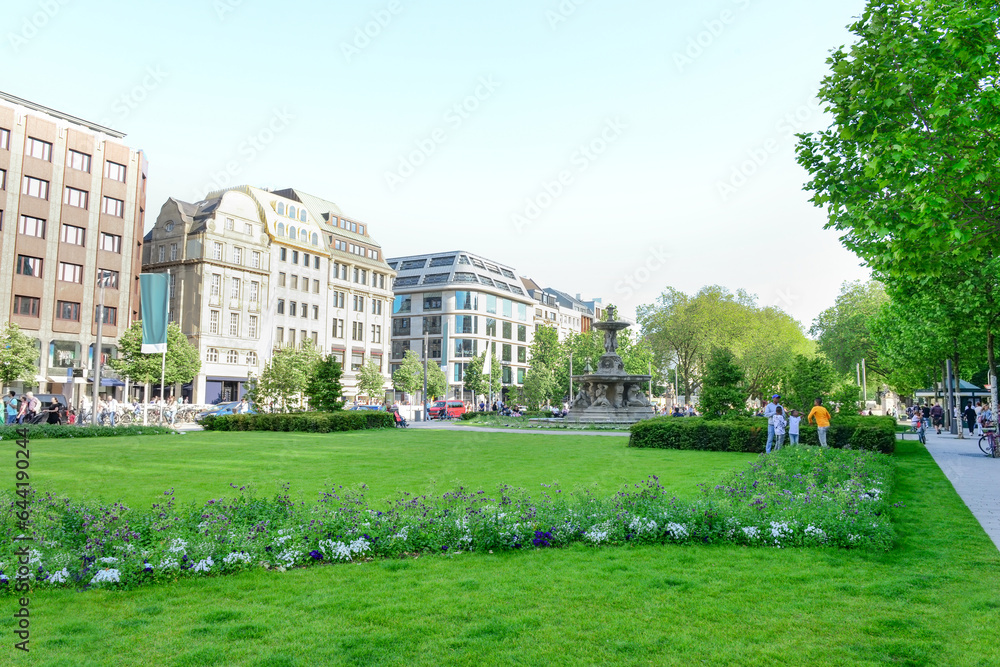 View of city street with fountain and buildings