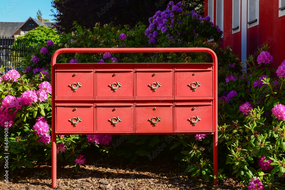 View of red mailboxes and flowers on street