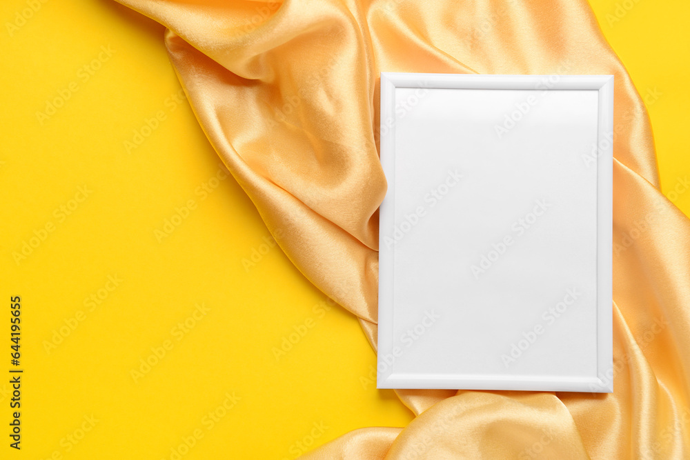 Blank picture frame with fabric on yellow background