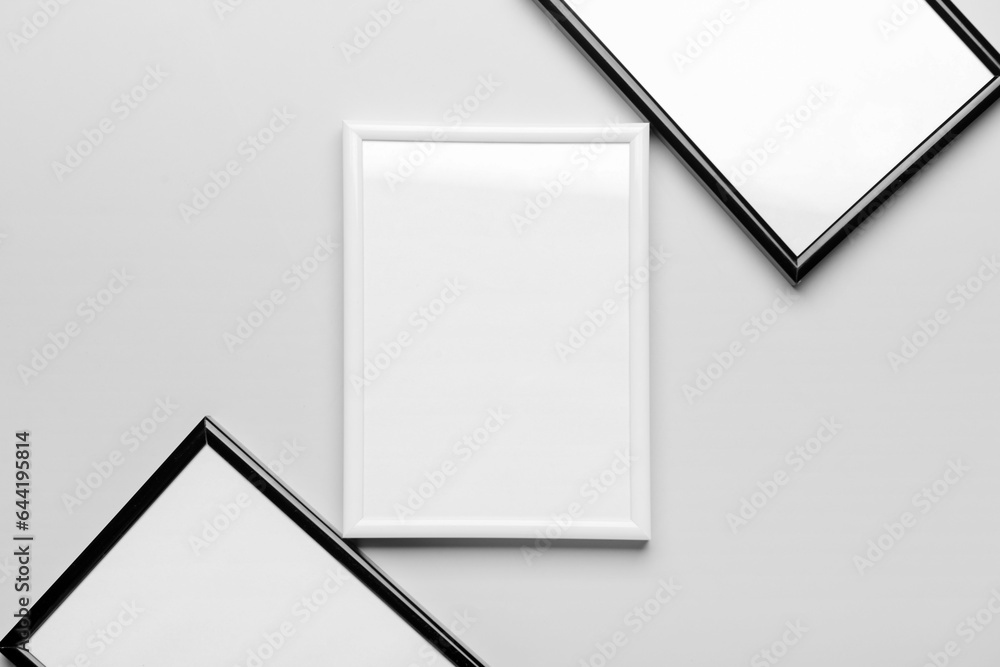 Blank picture frames on light background