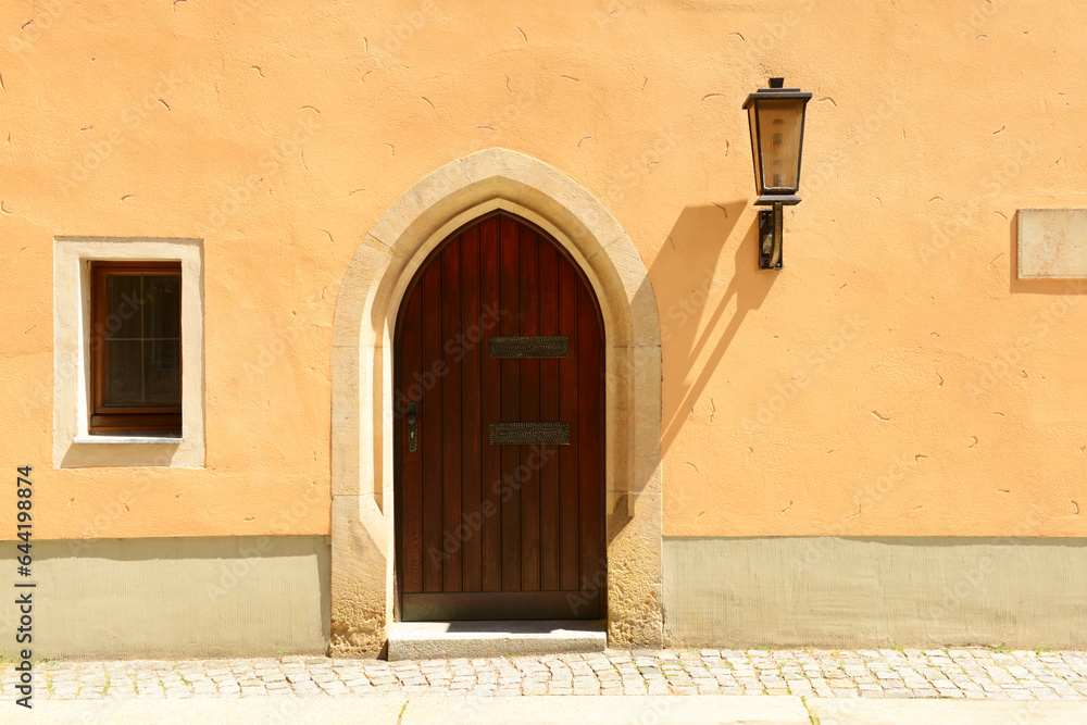 View of old building with wooden door and window