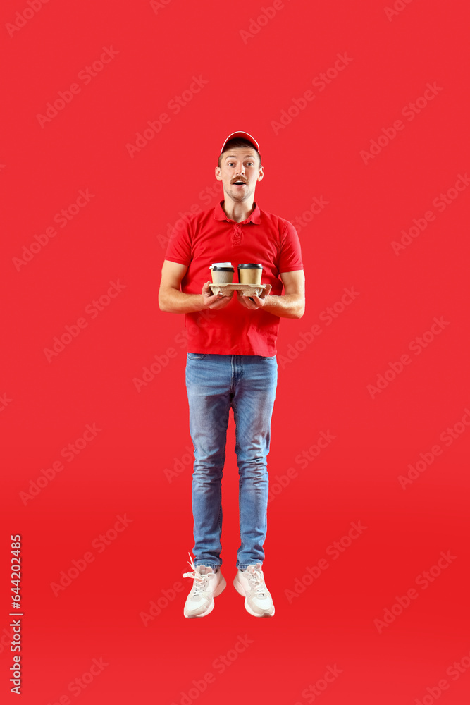 Jumping courier with coffee on red background