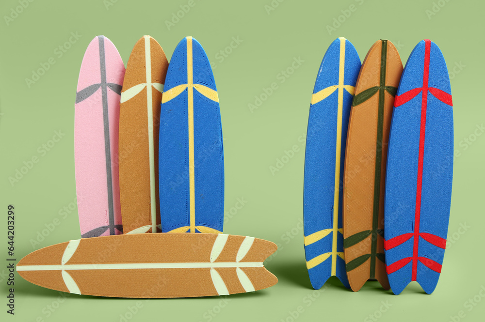 Different mini surfboards on green background