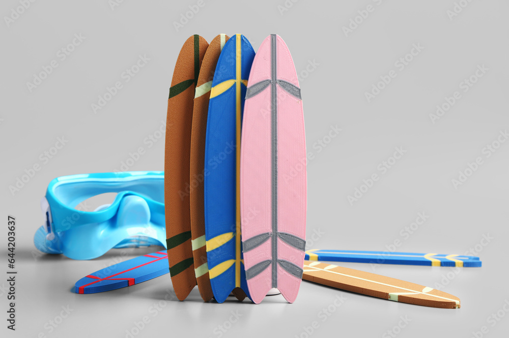 Different mini surfboards on grey background