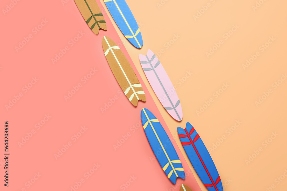 Different mini surfboards on color background