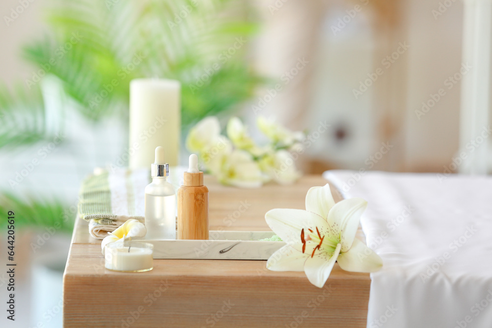 Spa composition with flowers on table in salon, closeup