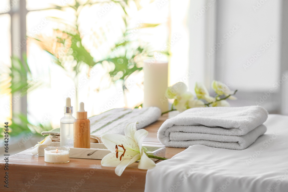 Spa composition with flower on table in salon, closeup