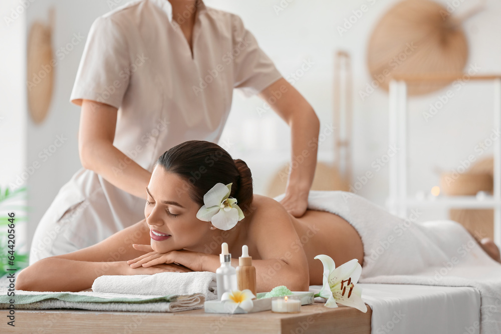 Young woman getting massage in spa salon, closeup