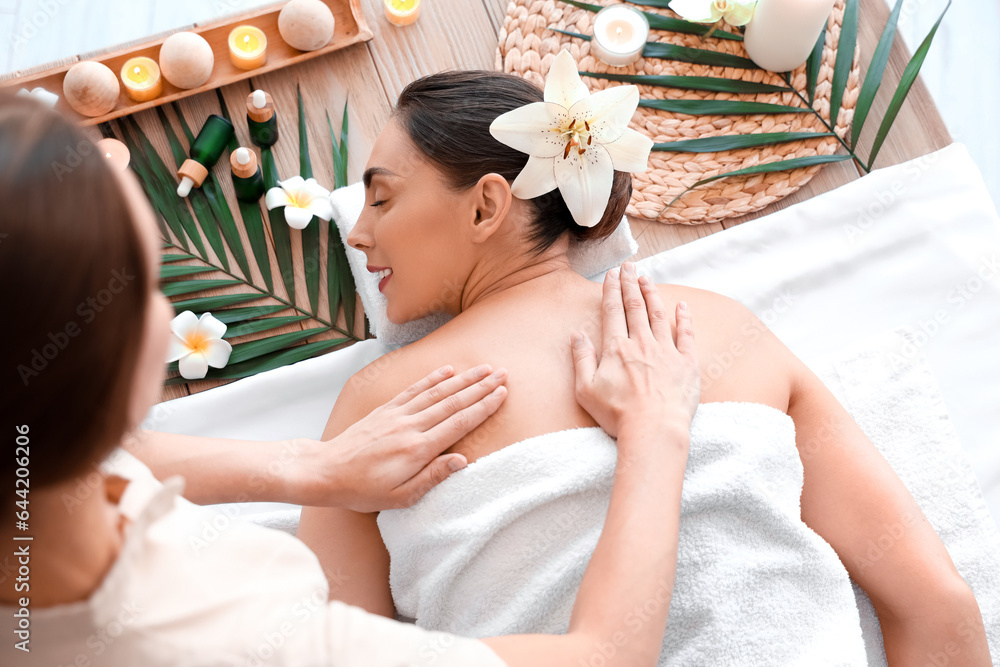 Young woman getting massage in spa salon, top view