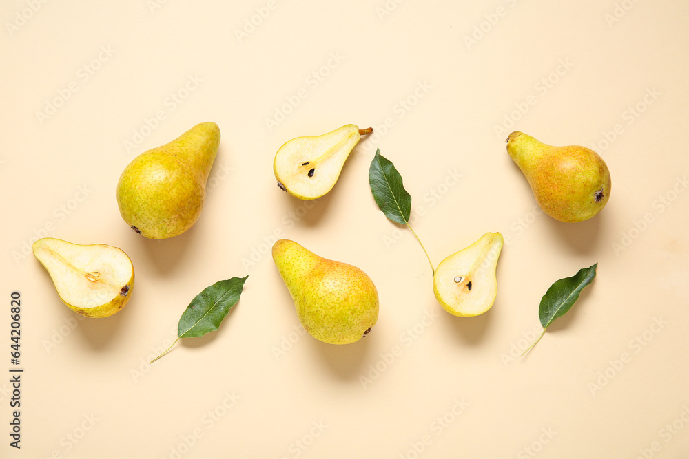 Ripe pears and leaves on yellow background