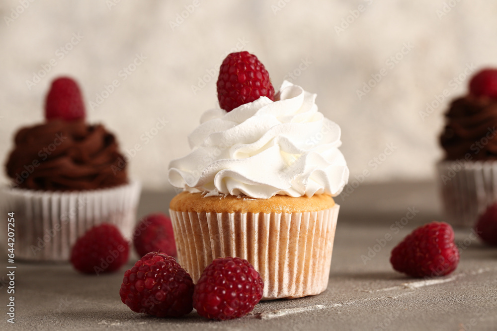 Tasty raspberry cupcake on table