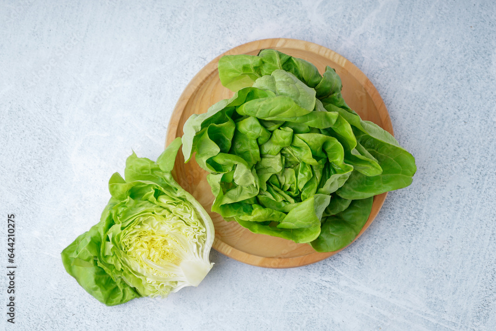 Plate with fresh Boston lettuce on white background