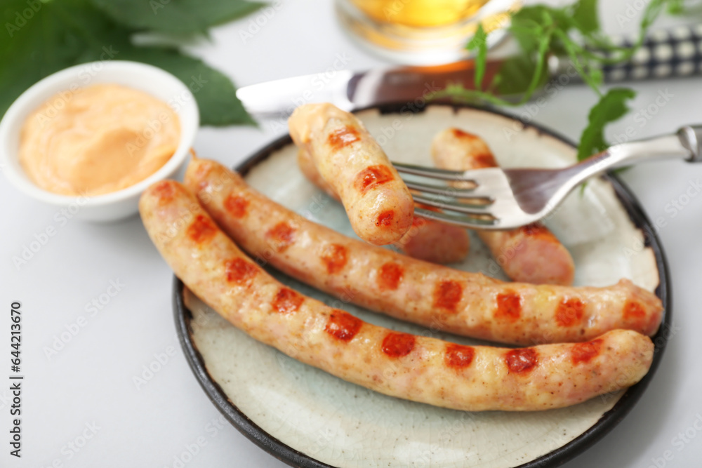 Plate with tasty Bavarian sausages on grey background. Oktoberfest celebration