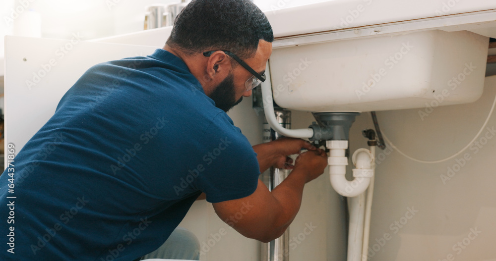 Plumber black man, kitchen and sink maintenance with tools, focus and pipe repair for drainage in ho