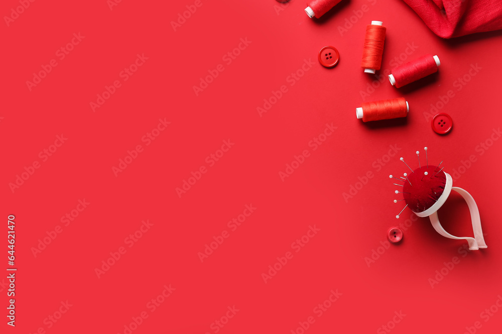 Composition with sewing supplies on red background