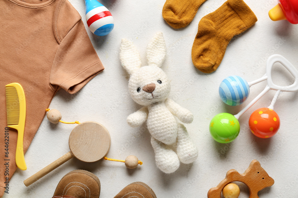 Composition with baby accessories and clothes on light background