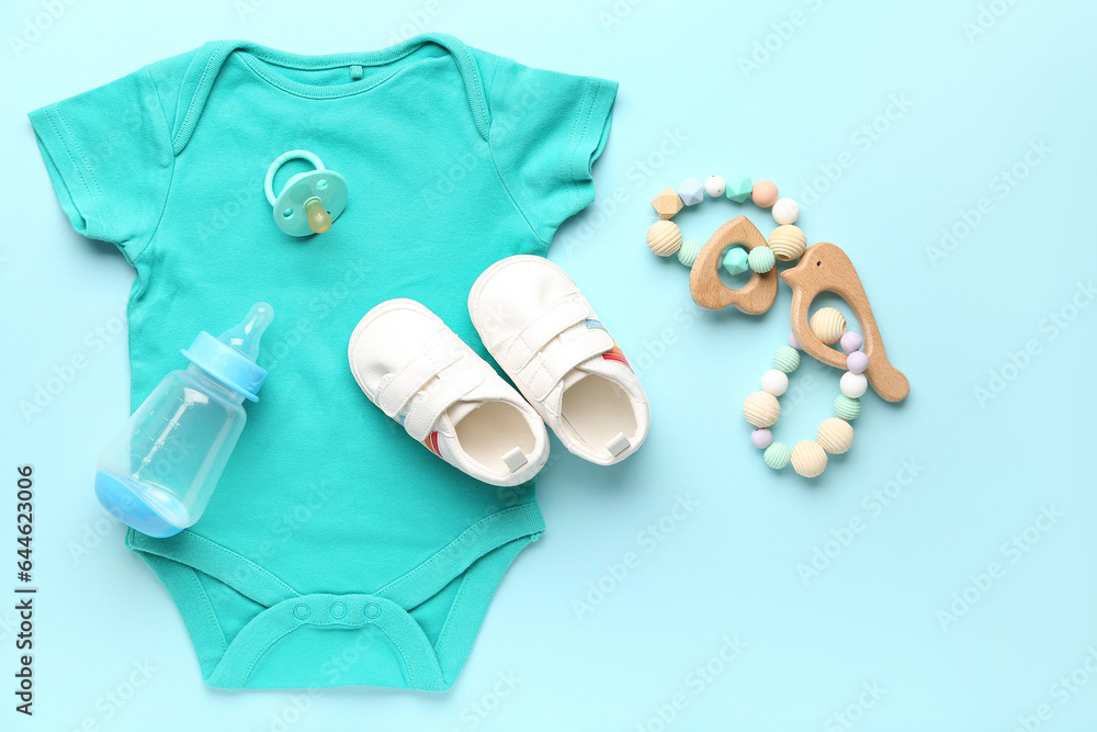 Set of baby accessories and clothes on color background