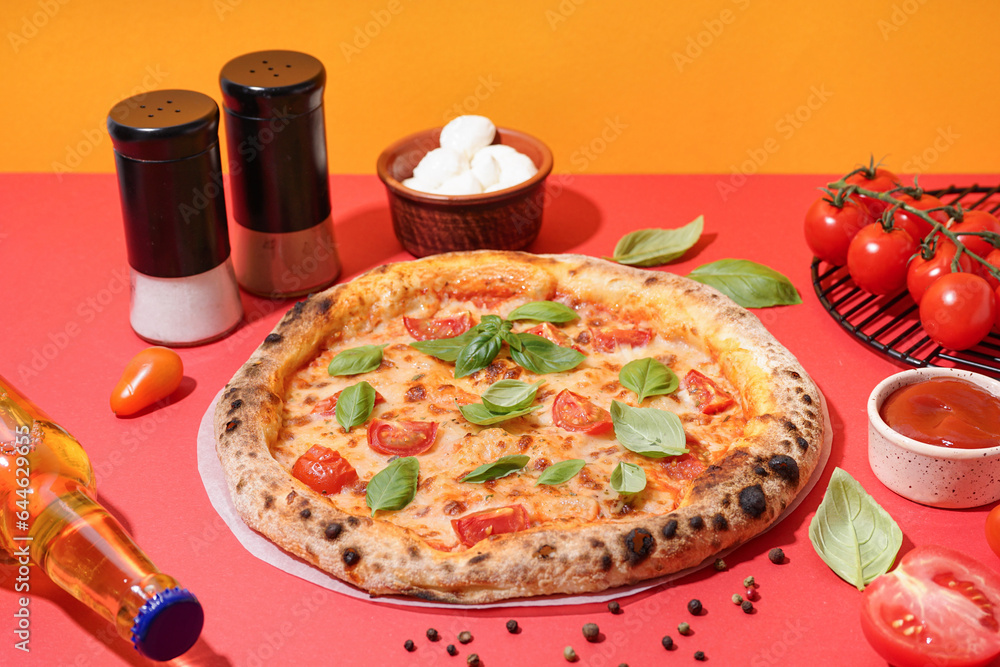 Tasty pizza Margarita with tomatoes and basil on red table