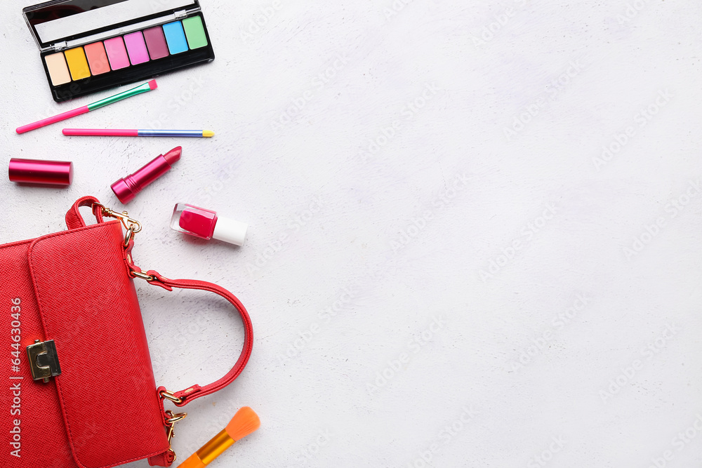 Composition with decorative cosmetics and female accessories on light background