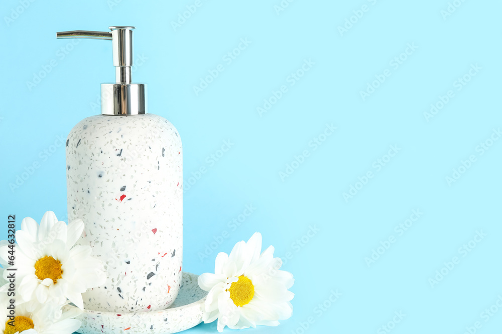 Bottle of cosmetic product and beautiful chamomile flowers on color background