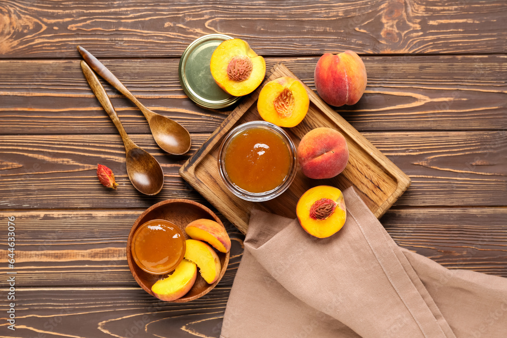 Composition with jar of sweet peach jam and fresh fruits on wooden background