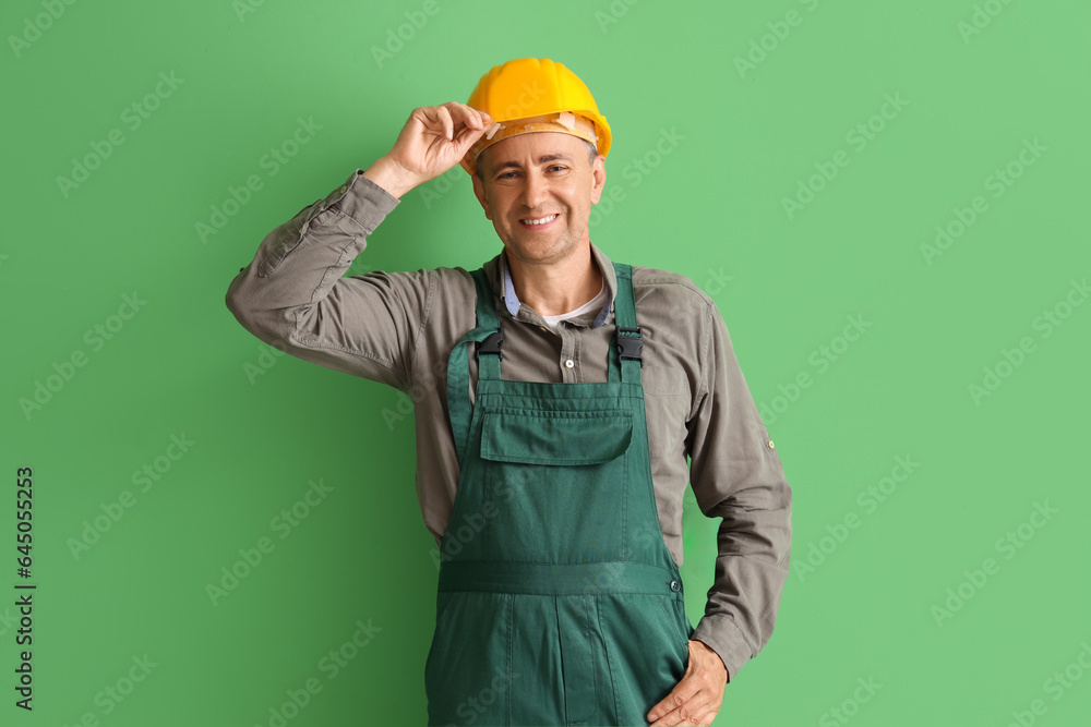 Mature builder on green background