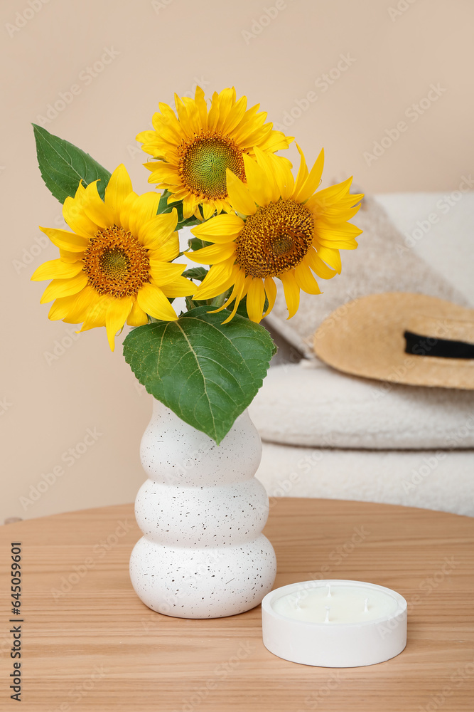 Vase with sunflowers on table in living room