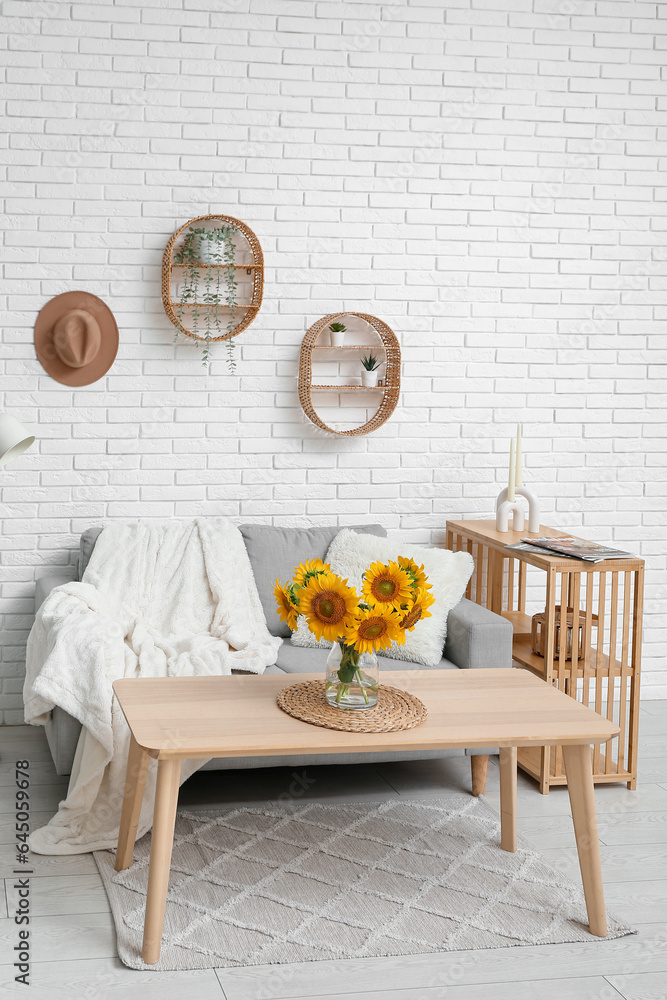 Interior of living room with sunflowers in vase on table