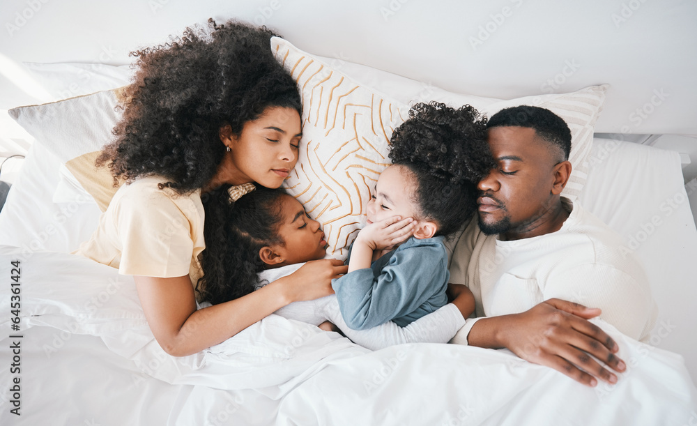 Mom, dad and kids in bed, sleeping and top view for care, hug and relax together on holiday in famil