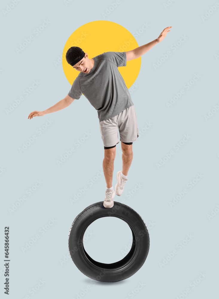 Sporty young man balancing on white background