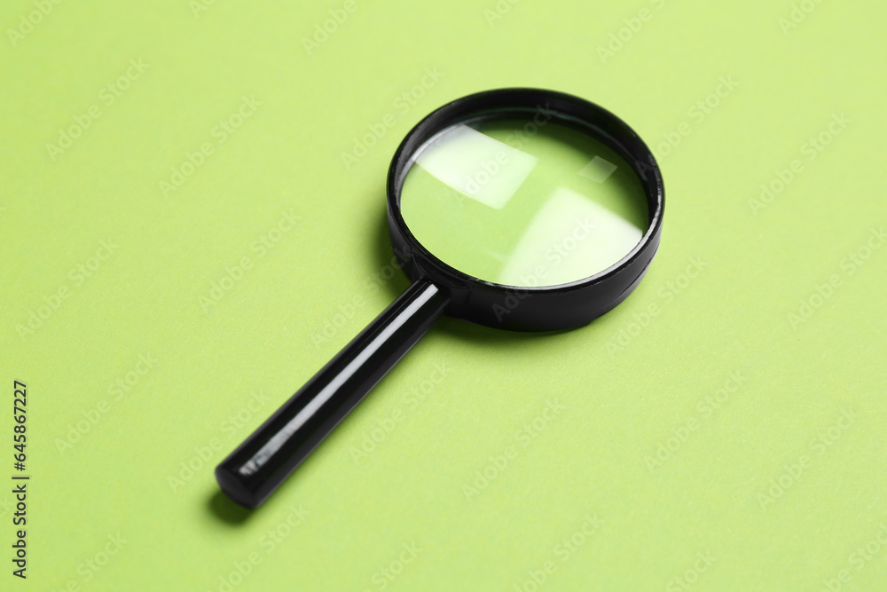 Black mini magnifier on green background