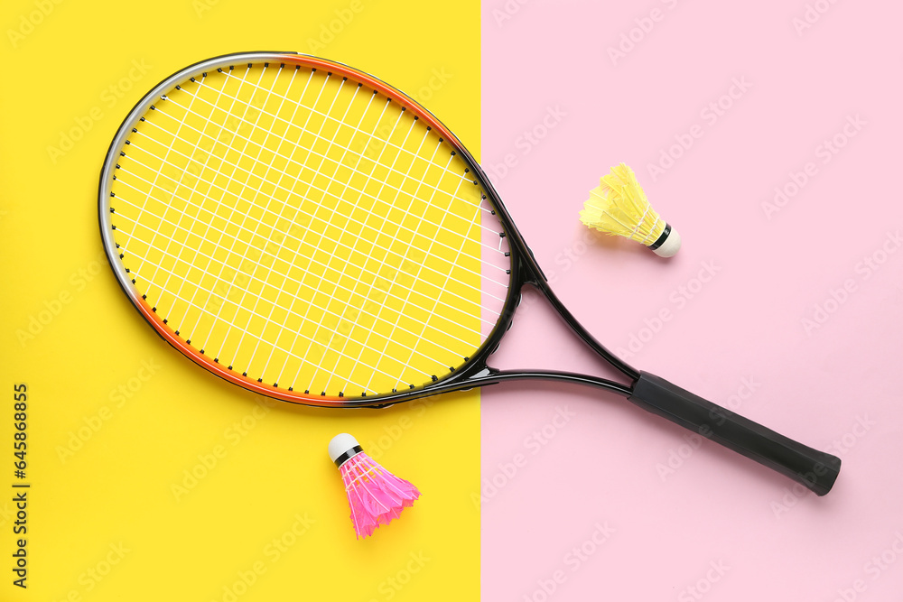 Badminton shuttlecocks and racket on color background