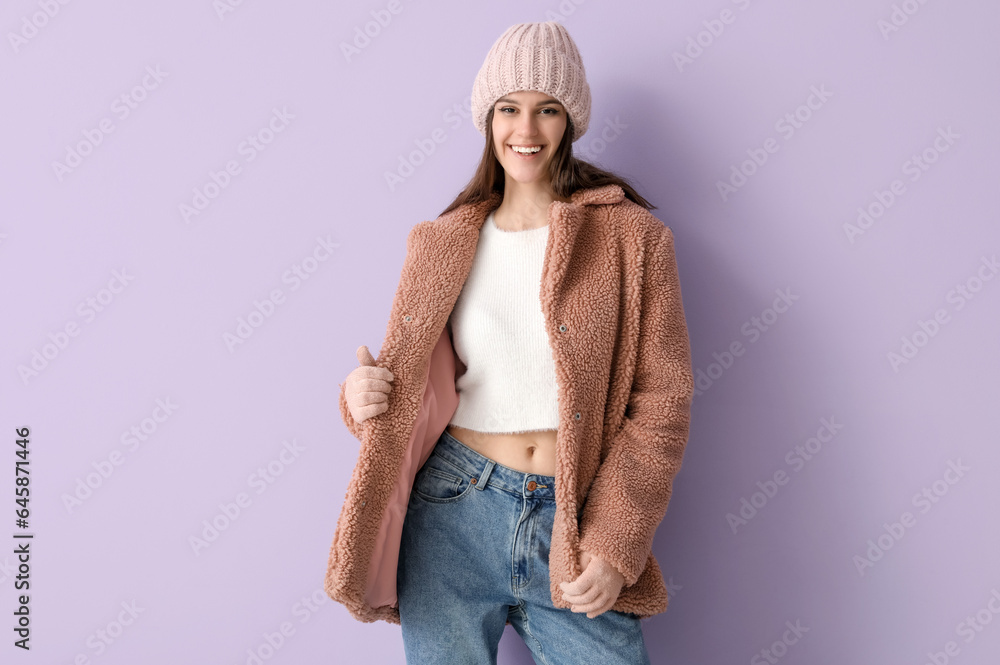 Young woman in teddy coat on lilac background