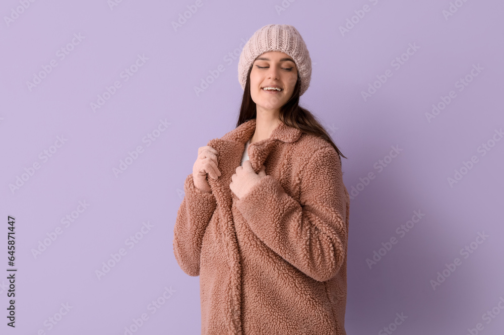 Young woman in teddy coat on lilac background