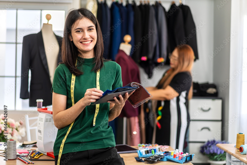 Portrait of young beautiful woman fashion designer stylish sitting and working with color samples.At