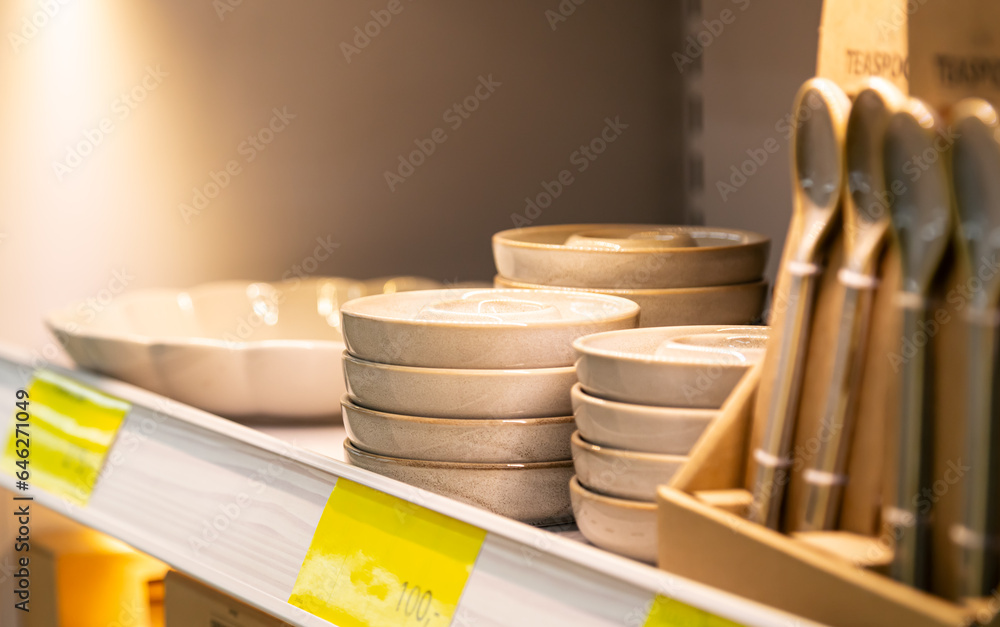 Shelf with ceramic plates for sell in a tableware store.