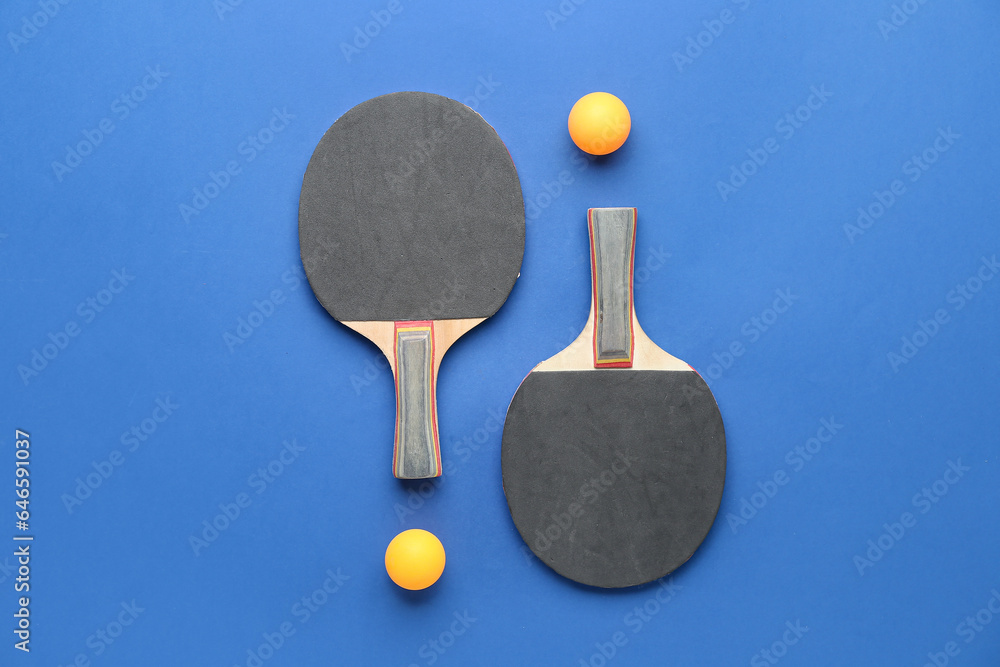 Ping pong rackets and balls on color background