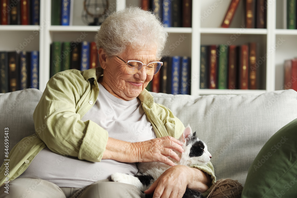 Senior woman with cute cat resting at home