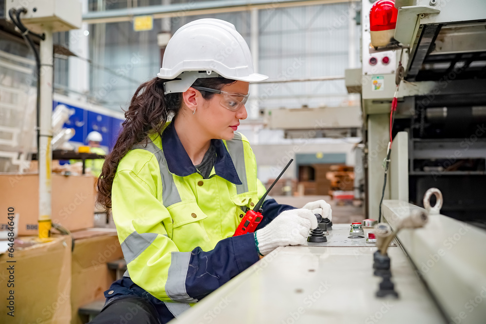 Industrial worker indoors in factory. Young technician with orange hard hat. Smart Caucasian factory