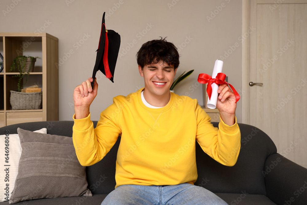 Male graduate student with diploma video chatting at home