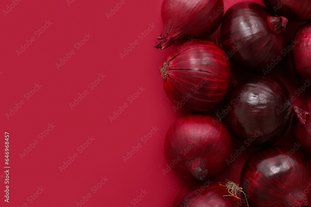 Fresh red onions on color background