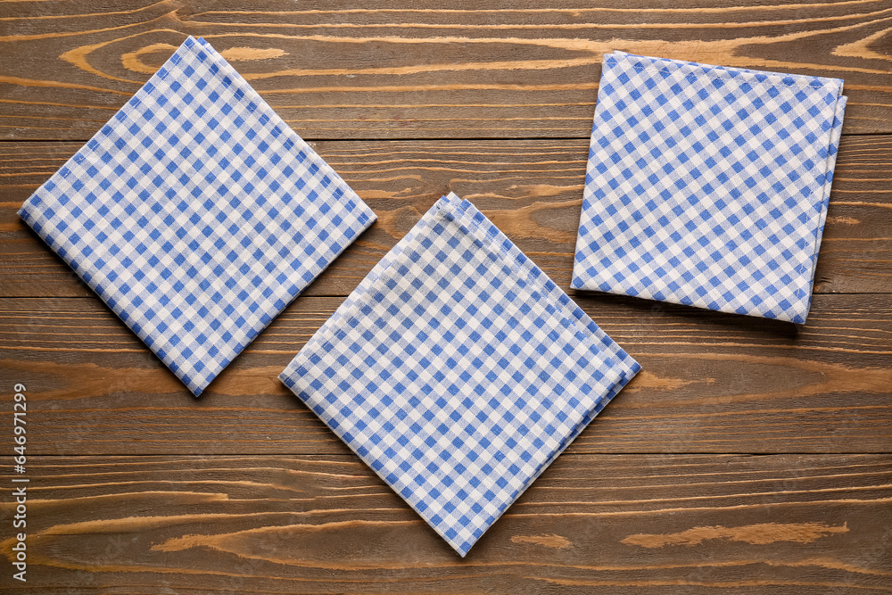 Set of clean napkins on wooden background