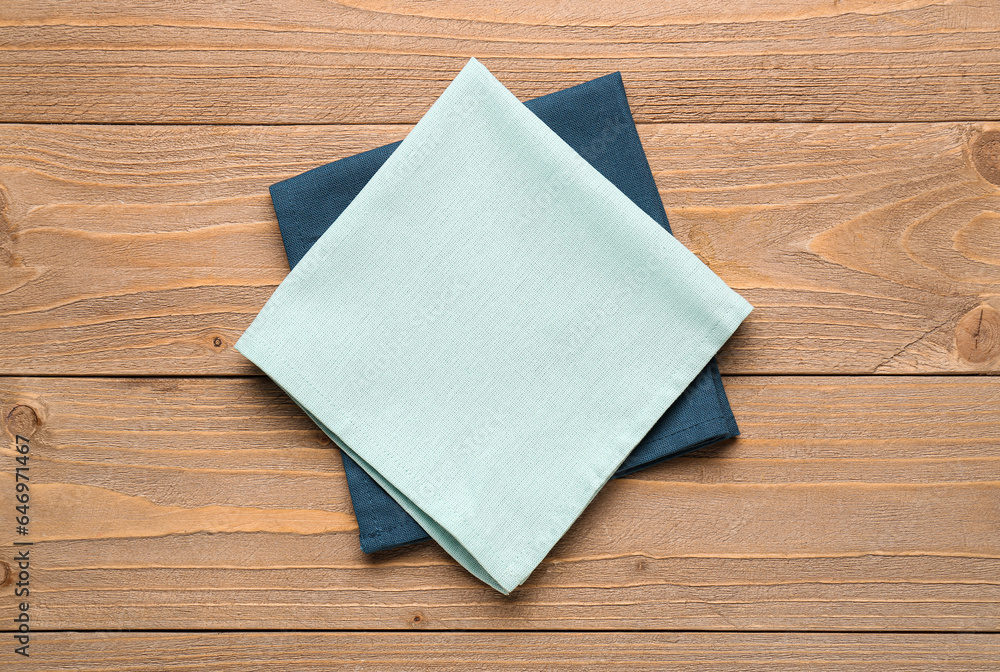 Clean folded napkins on wooden background